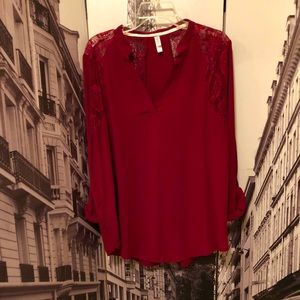 A long sleeve burgundy shirt with a lace pattern.